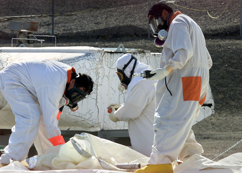 Workers at the Hanford nuclear reservation near Richland, Wash., measure for radiation in 2004. The site was created in the 1940s as part of the project to build the atomic bomb.