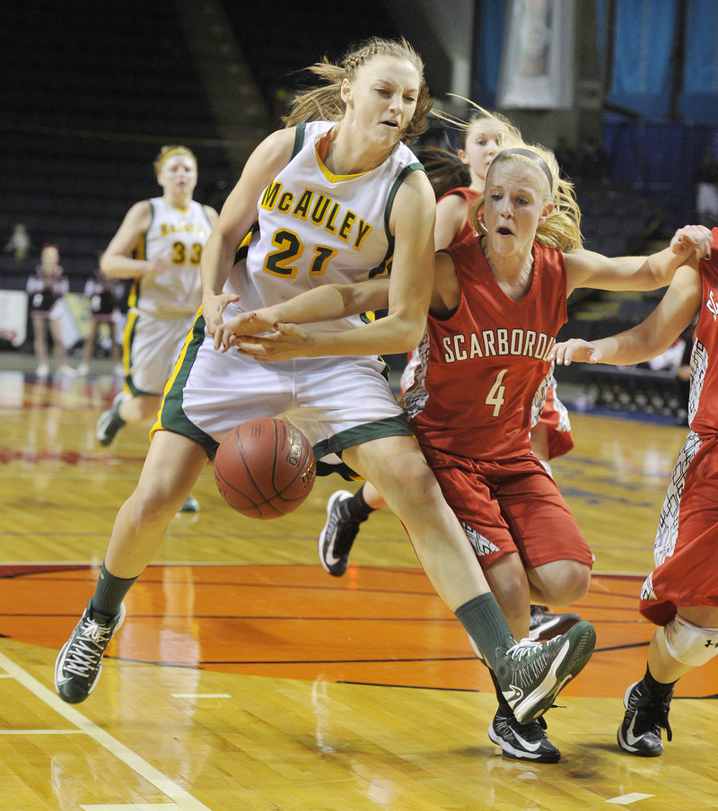 Olivia Smith of McAuley is fouled by Maria Philbrick of Scarborough, who broke up a fast break.