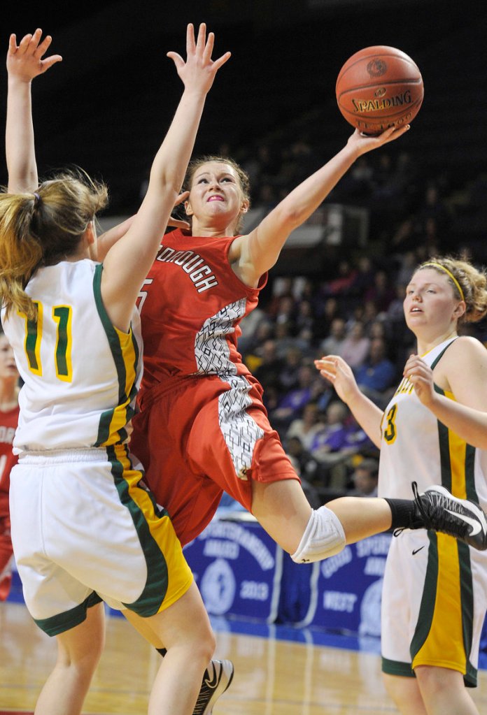 Mary Redmond of Scarborough tries to get a shot over Molly Mack of McAuley during McAuley’s 47-38 victory in a Western Class A girls’ basketball semifinal Friday night at the Cumberland County Civic Center.