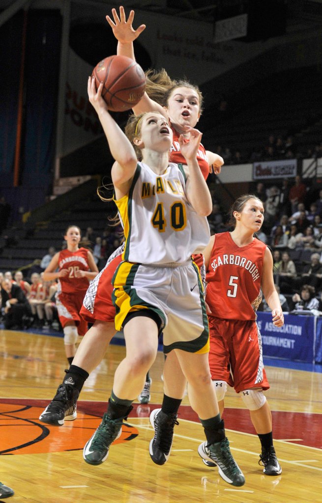 Jaclyn Welch of McAuley drives to the basket ahead of Courtney Alofs of Scarborough during McAuley’s 47-38 victory Friday night in a Western Class A girls’ basketball semifinal at the Cumberland County Civic Center.
