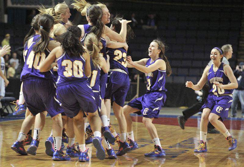 The Cheverus High girls’ basketball players rush the court Friday night after holding on to a 33-31 victory against Deering in the Western Class A semifinals at the Cumberland County Civic Center. The Stags will meet McAuley for the title Saturday night.