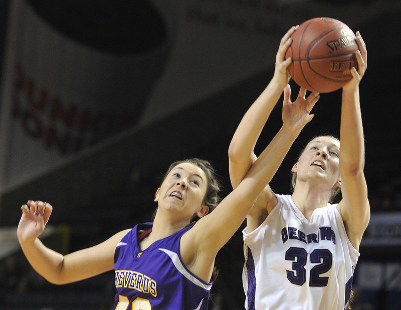 Jess Willerson, left, of Cheverus tries to knock a rebound away from Marissa MacMillan of Deering during their Western Class A girls’ basketball semifinal Friday night at the Cumberland County Civic Center. Cheverus won 33-31 and will meet McAuley for the title.