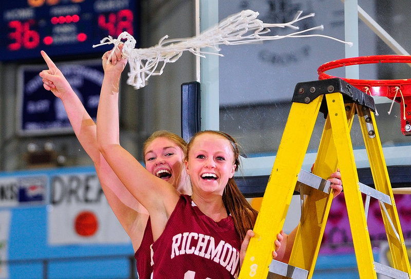 The Richmond captains – Brianna Snedeker, left, and Noell Acord – tear down the net at the Augusta Civic Center after beating Rangeley in Western Class D, 48-36.