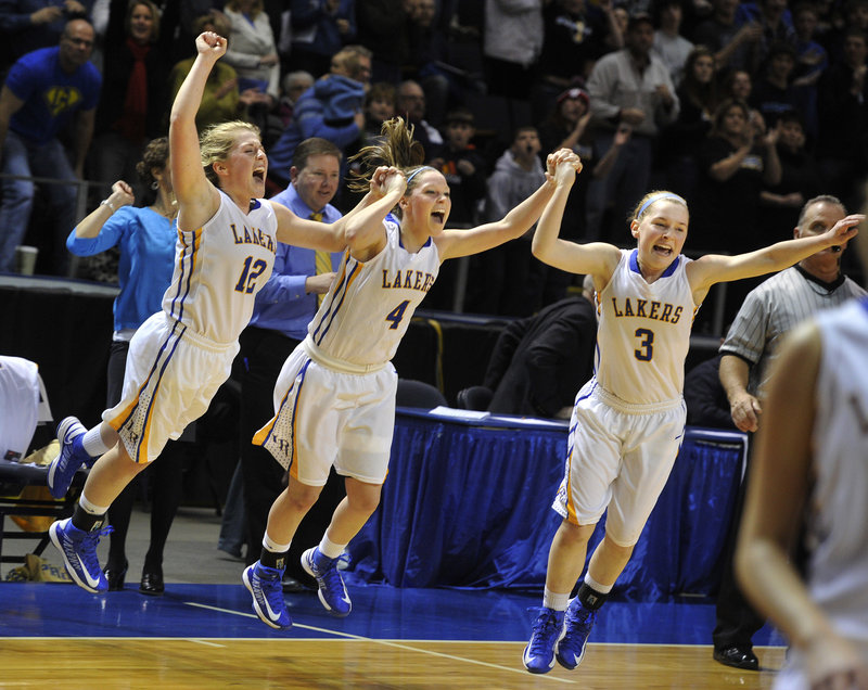 The Hancock girls, from left, Sarah, Sydney and CeCe, leap onto the court Saturday as Lake Region completes its victory against York in Western Class B.