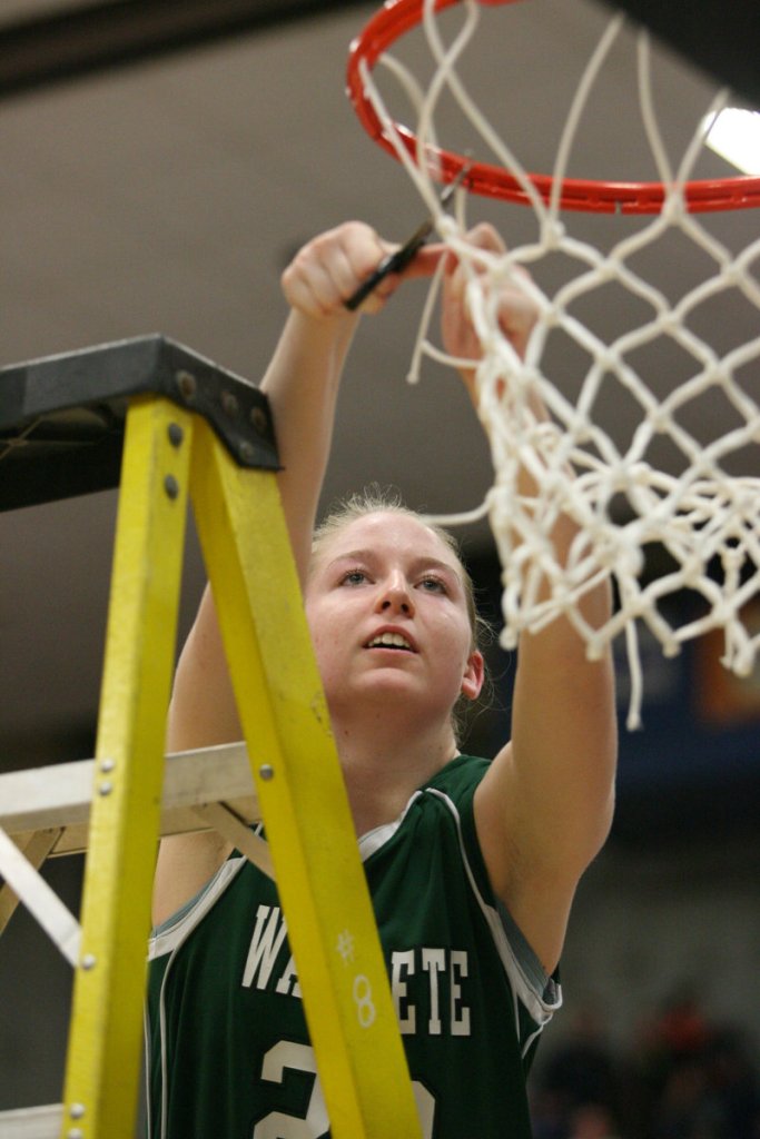 Waynflete’s Catherine Veroneau cuts the net down after the Flyers won their Western Class C regional final at the Augusta Civic Center.