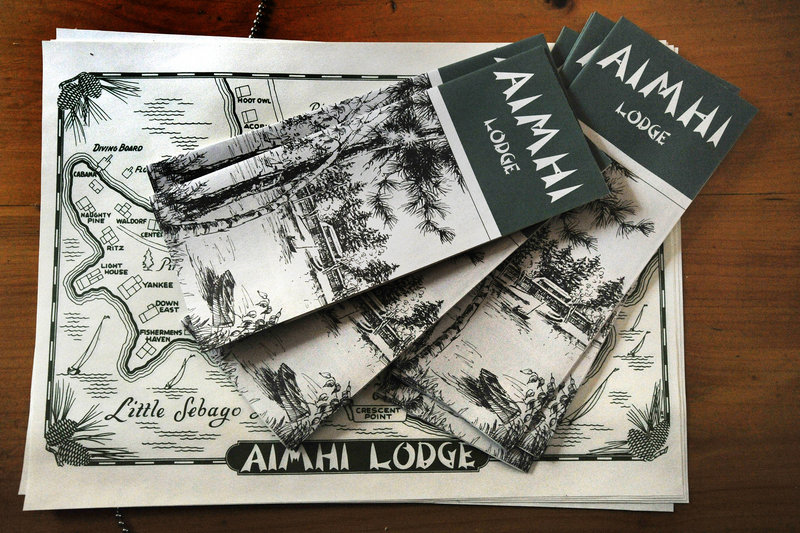 A stack of brochures and maps describe Aimhi Lodge and offer a guide to exploring the once-popular family lodge on Little Sebago Lake that featured two dozen cabins and a main lodge on 25 acres of waterfront land.