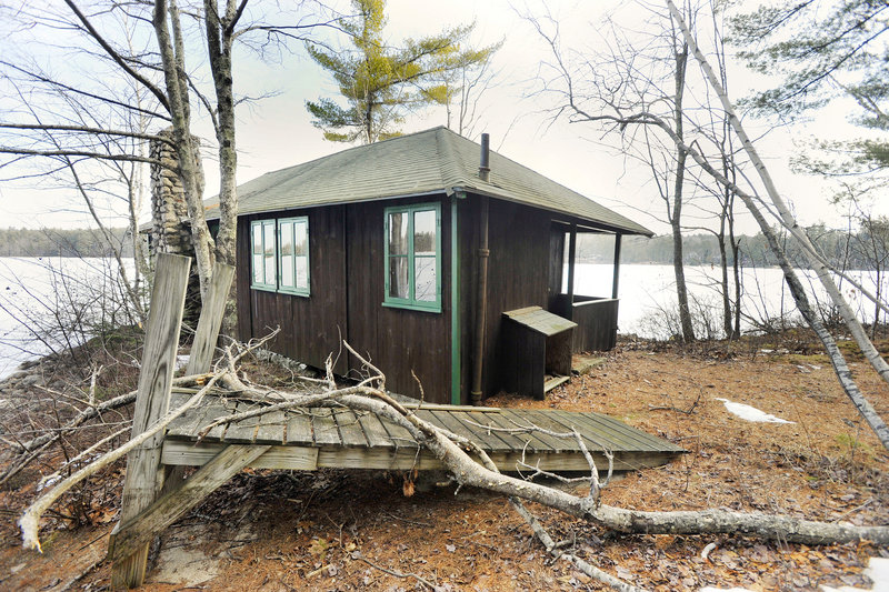 One of the camp’s cabins sits on the shore of the lake.
