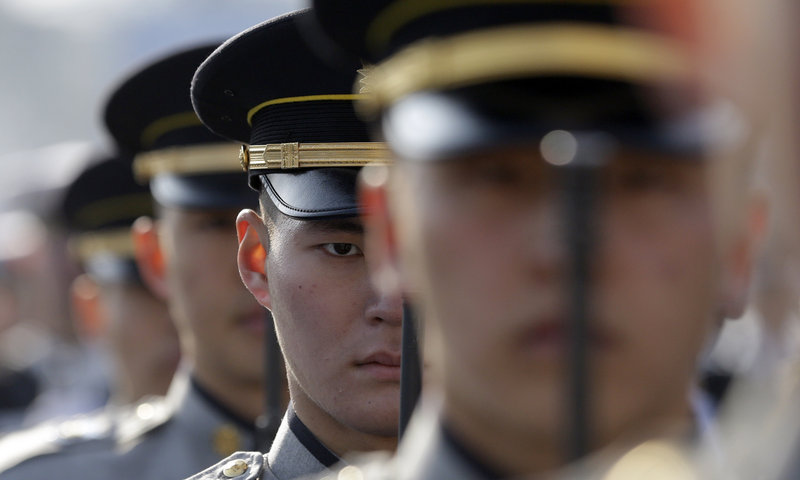 South Korean honor guards salute during a rehearsal of the presidential inauguration in Seoul, South Korea, on Sunday.