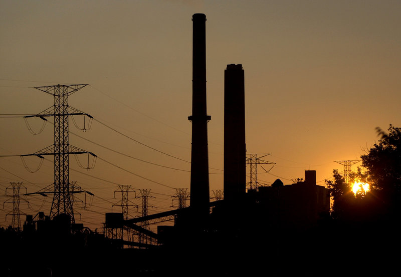 The sun sets behind a coal-fired power plant in Eastlake, Ohio. As part of a settlement with the government and environmental groups, American Electric Power has agreed to stop burning coal at three of its power plants by 2015.