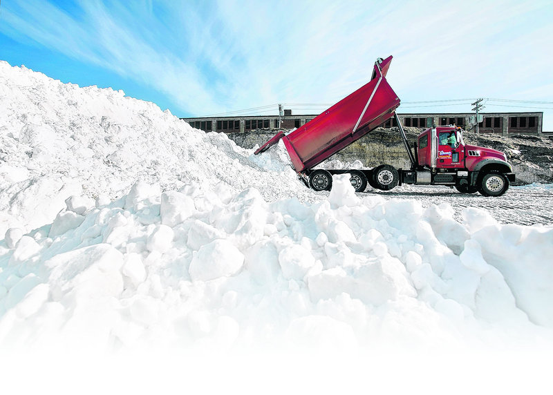 Snow is dumped in a lot near Preble Street during the clean-up from the record-setting blizzard in Portland on Feb. 10.