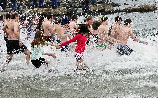 The bravehearted take the plunge in the 2012 Camp Sunshine “Freezin’ for a Reason” Polar Dip at Portland’s East End Beach. The 2013 dip takes place at noon Saturday.