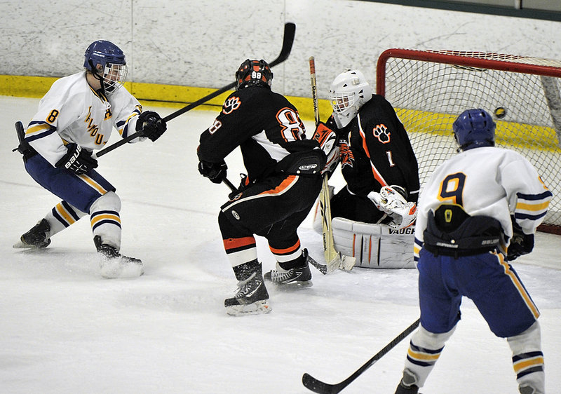 Hugh Grygiel of Falmouth puts the puck past Biddeford goalie Jon Fields, giving the Yachtsmen a 2-0 lead Tuesday night in their Western Class A quarterfinal at Family Ice. Looking to help guard the net for Biddeford is Kerry Crepeau.