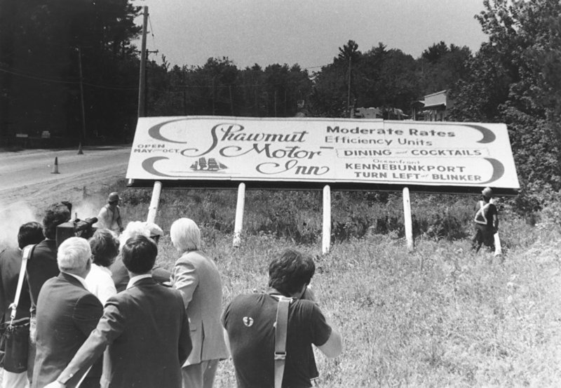 The last state-acquired billboard in Maine, on Route 1 in York County, is cut down by chain saw circa 1984.