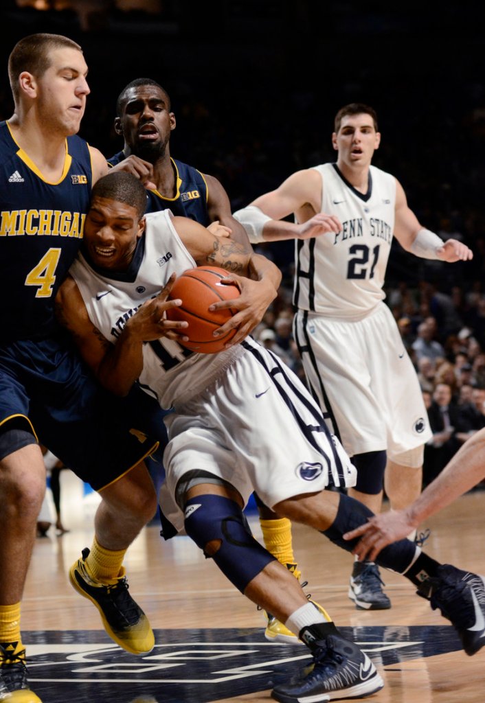 Penn State’s Jermaine Marshall drives into Michigan’s Mitch McGary during the first half of Penn State’s big 84-78 upset of the Wolverines at State College, Pa., on Wednesday.