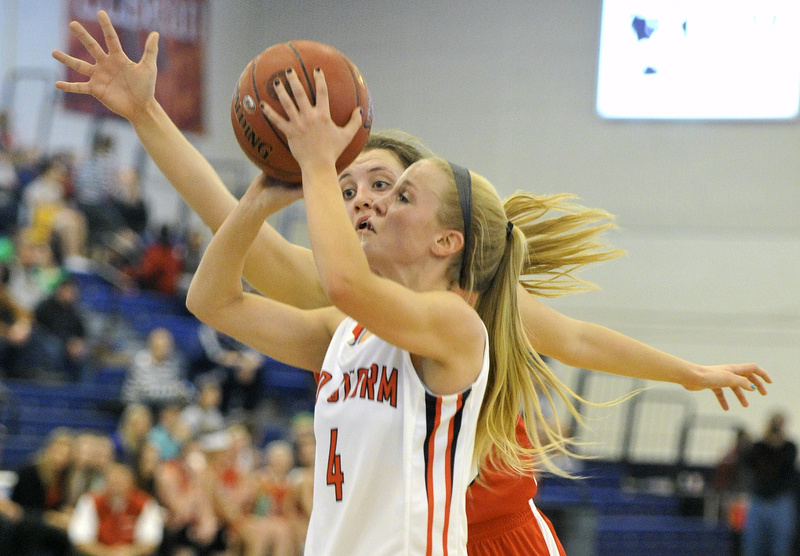 Maria Philbrick of Scarborough looks to get off a shot while defended by Brianne Maloney of South Portland. Scarborough won 45-32 to set up a game with McAuley.