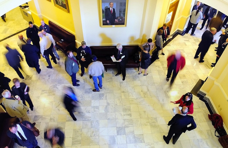 In this file photo, people move through the third floor between the House and Senate chambers at the State House in Augusta. The Maine Legislature's budget-writing committee made progress Thursday on an emergency spending plan to fix Maine's $153 million budget shortfall.