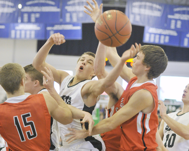 Dustin Cole of Bonny Eagle looks for a rebound between Sam Wessel, left, and Sam Terry of Scarborough during Bonny Eagle’s 48-32 win in Western Class A.