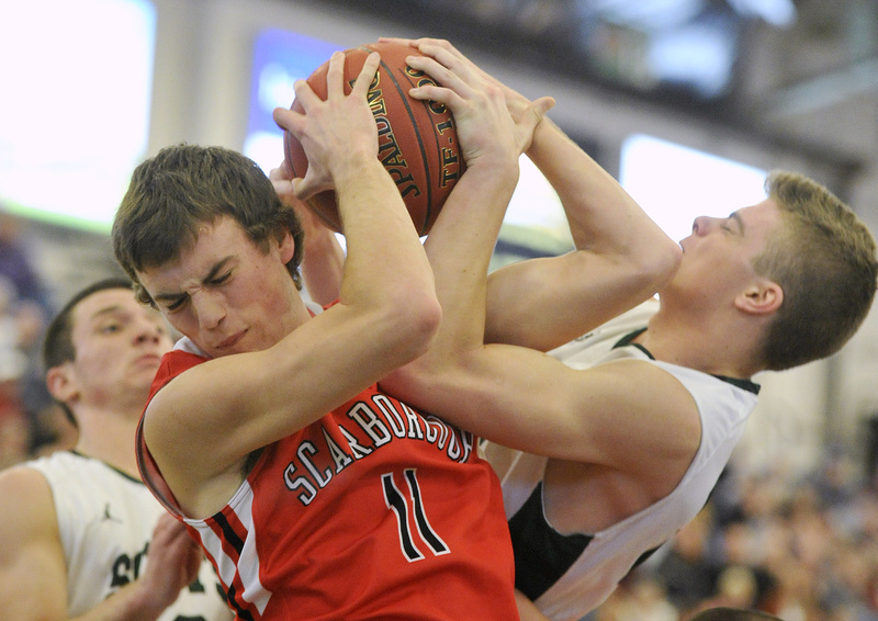 Sam Terry of Scarborough competes for a rebound with Jonathan Thomas during Bonny Eagle’s 48-32 victory Saturday night at the Portland Expo. The Scots will meet Thornton Academy in the Western Class A semifinals.