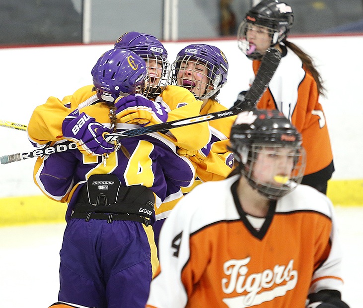 Abby Biegel of Cheverus celebrates between teammates Paige Severance, 24, and Katie Randall after scoring early in a 7-4 victory against Biddeford in a Western Maine girls’ hockey quarterfinal Wednesday night.