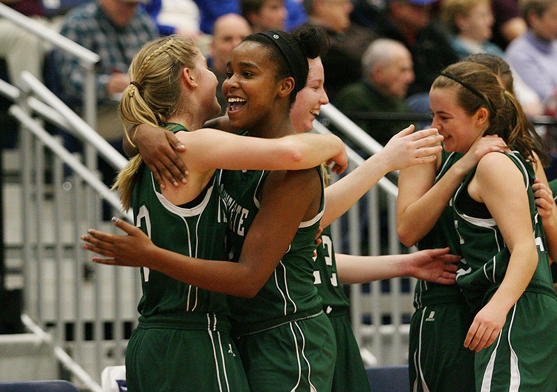 Rhiannan Jackson, center, hugs Martha Veroneau after Waynflete captured the Western Class C title by defeating Madison 63-41 at the Augusta Civic Center.