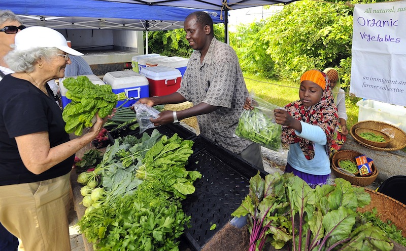 In this 2011 file photo, Nancy Gage of South Portland, left, buys Swiss Chard from Mohamed Abukar, who sells organic vegetables from Fresh Start Farms in Lisbon at the South Portland farmers market. The market, which was established in 2011, is without a home for the upcoming summer season, according to its manager.