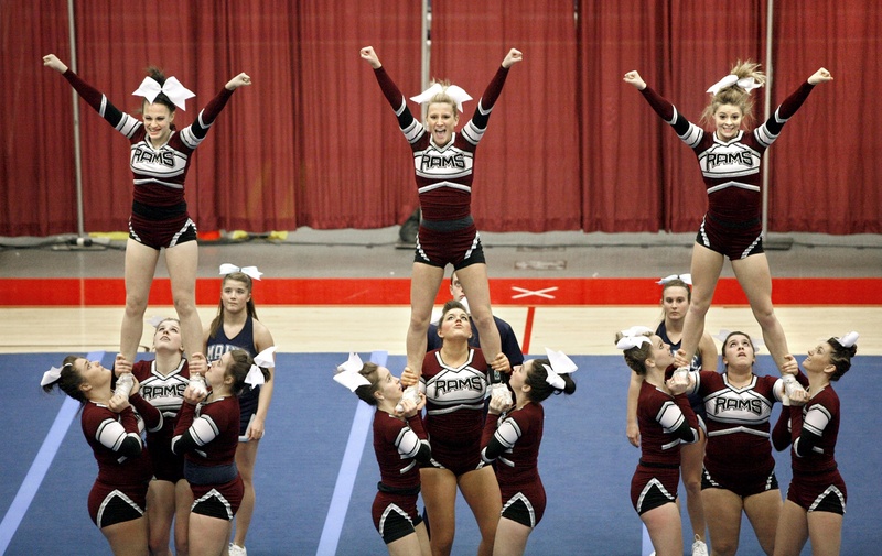 Cheerleaders from Gorham High School complete a three-person pyramid during their routine at the Class A East/West State Cheerleading Competition in February 2012.