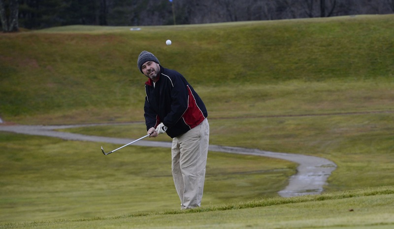 In this Dec. 11, 2012 file photo, Mark McCarthy of Portland watches a chip shot go onto the green on the 7th hole at Riverside Golf Course in Portland. The city will keep operating the course, rather than leasing it to a golf course management company.