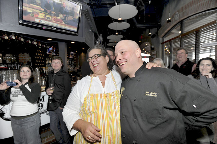 Lisa Kostopolos of The Good Table Restaurant and Jeff Landry of The Farmer's Table react after learning they would share first place at The Incredible Breakfast Cook-Off held at Sea Dog Brewing Co. in South Portland on Friday.