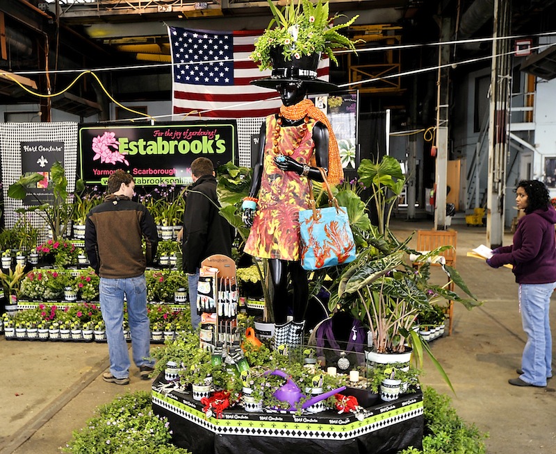 Workers check out Estabrook's display that greets visitors to the 2013 Portland Flower Show at the Portland Complex on Wednesday, March 06, 2013.