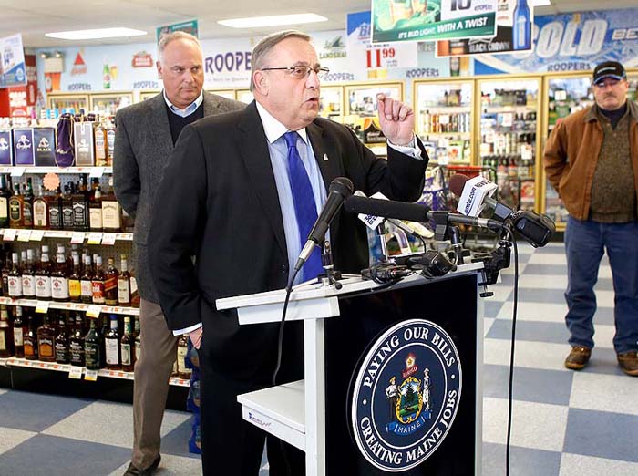 Gov. Paul LePage speaks to the media Friday during his visit to Roopers Beverage in Auburn to discuss his plan to pay back hospital debt by leveraging future liquor sale revenue.