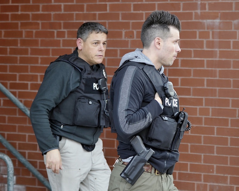 Police surround the Lafayette Square apartment complex after shots were fired on the sixth floor on Friday, March 15, 2013.