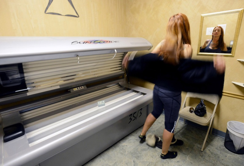 Hillary Cooledge, 28, of Portland, prepares to use a tanning bed at Sun Tiki Tanning in Portland on Thursday, March 28, 2013. Proponents say a proposed law to ban underage tanning would prevent harm to young people, but salon owners say the measure would hurt business.
