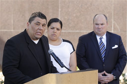 Plaintiff Michael Duran, left, who received nearly $1 million in a sex abuse settlement with the Roman Catholic Archdiocese of Los Angeles, speaks during a news conference on Thursday, March 14, 2013 in Los Angeles. Duran was molested by ex-priest Michael Baker, who is now in jail after pleading guilty to a dozen sex charges. The U.S. church's challenges include recovering from the clergy sexual abuse scandal, which has resulted in the bankruptcies of prominent archdioceses and cost the Church in America an estimated $3 billion in legal settlements. Duran's wife, Margarita, center, and his attorney John Manly look on. (AP Photo/Damian Dovarganes)