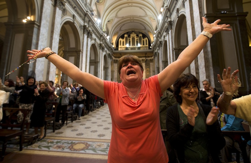 Paola La Rocca celebrates after hearing on the speakers at the Metropolitan Cathedral that Buenos Aires' Archbishop Jorge Bergoglio was chosen as Pope in Buenos Aires, Argentina, Wednesday, March 13, 2013. Bergoglio is the first pope ever from the Americas and the first from outside Europe in more than a millennium. (AP Photo/Victor R. Caivano)