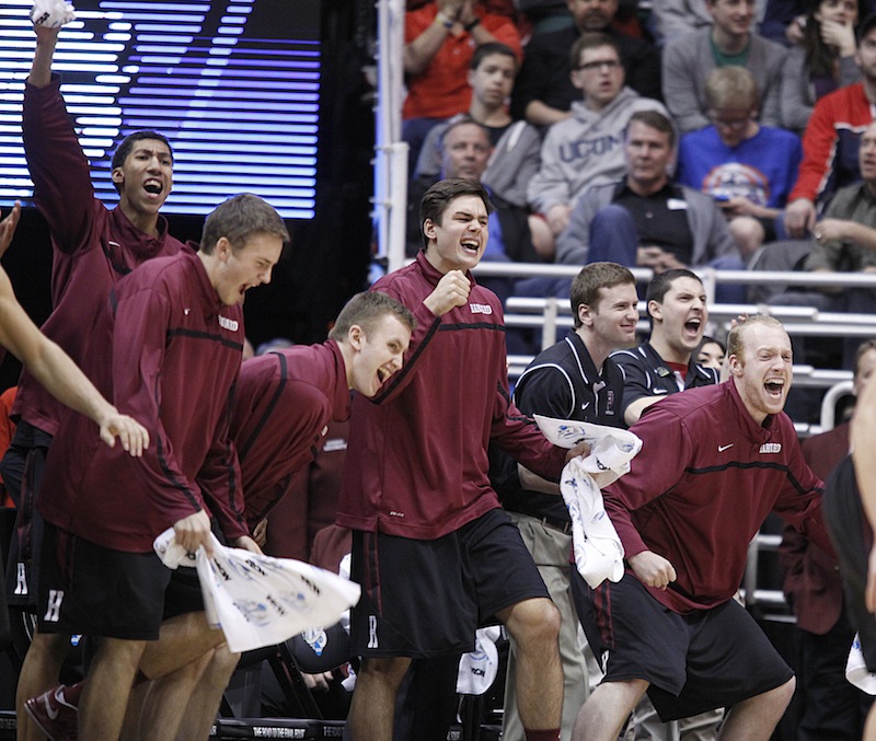 Harvard players celebrate on the bench after beating New Mexico during a second round game in the NCAA college basketball tournament in Salt Lake City Thursday, March 21, 2013. Harvard beat New Mexico 68-62. (AP Photo/George Frey)