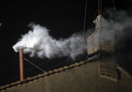 White smoke emerges from the chimney on the roof of the Sistine Chapel at the Vatican on Wednesday.