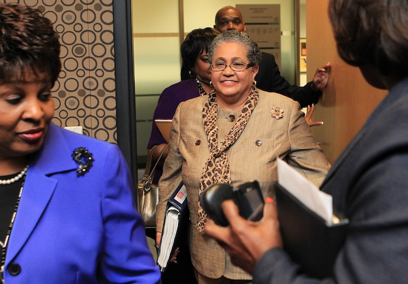 In this June 13, 2011 file photo, outgoing schools superintendent, Dr. Beverly Hall, center, arrives for her last Atlanta school board meeting at the Atlanta Public Schools headquarters in Atlanta. Hall and nearly three dozen other administrators, teachers, principals and other educators were indicted Friday, March 29, 2013, in one of the nation's largest cheating scandals. (AP Photo/Atlanta Journal-Constitution, Curtis Compton) Beverly Hall