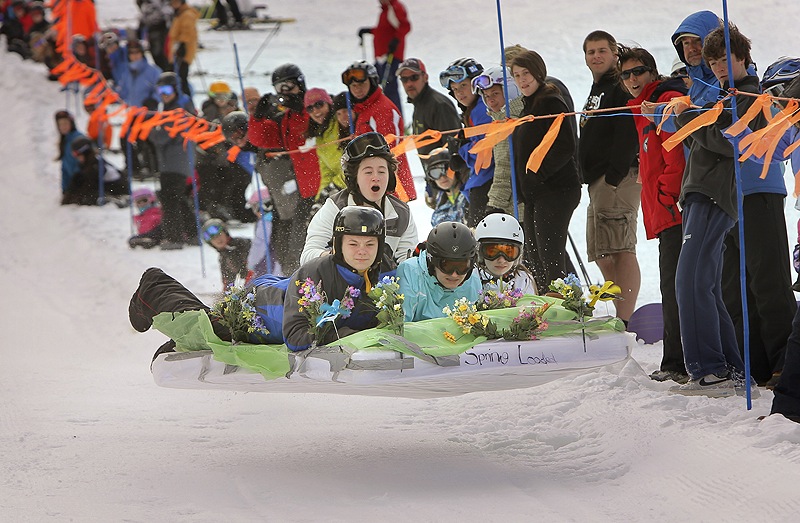 A team dubbed Spring Loaded, Eddie Grace, Noelle Veillette, Catherine Menousek and Amy McGurk, left to right, gets some air while competing in the 6th annual Mattress Race at Shawnee Peak in Bridgton on Saturday. The team came in fourth in the race.