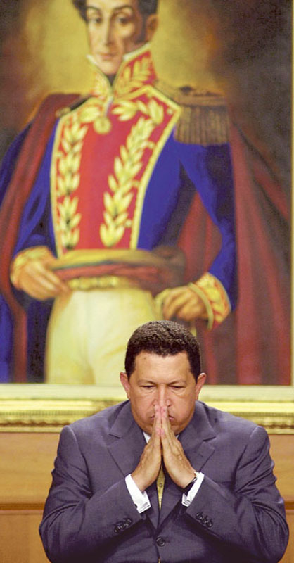 Chavez sits before a painting of Venezuelan independence hero Simon Bolivar at the presidential palace in Caracas.