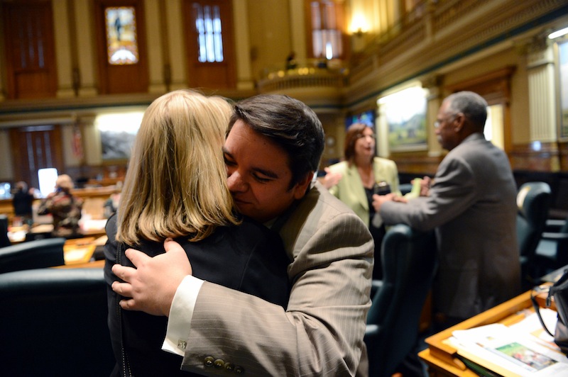 Colorado Rep. Dominick Moreno, D-Commerce City, gets a hug from Rep. Brittany Petteren, D-Lakewood, following Tuesday's vote on a bill giving gay couples rights similar to marriage.