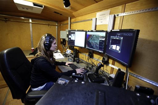 Flight test operator Hannah Rasmussen monitors unmanned aricraft controls at a ground control station in Arlington, Ore.