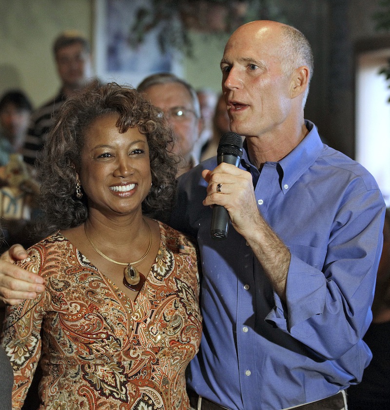 In this Oct. 26, 2010 file photo, Florida Republican gubernatorial candidate Rick Scott, right, puts his arm around running mate Rep. Jennifer Carroll, R-Jacksonville, during a campaign stop in New Port Richey, Fla. Carroll abruptly resigned Wednesday, March 13, 2012 after authorities questioned her ties into internet cafes that authorities say are fronts for gambling. (AP Photo/Chris O'Meara, File)