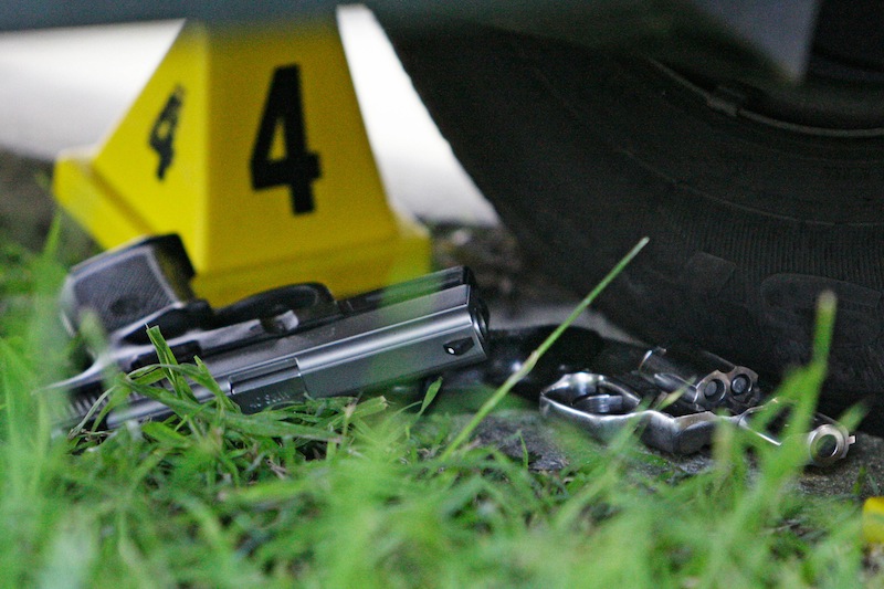 In this Tuesday, Feb. 24, 2009 file photo, two guns lie at the scene where five people were shot and two suspects were taken into custody in a shooting incident that happened along the Mardi Gras parade route in New Orleans. States with the most gun control laws have the fewest gun-related deaths, according to a study published Wednesday, March 6, 2013 in the medical journal JAMA Internal Medicine. The study suggests sheer quantity of measures might make a difference. States with the fewest laws and most deaths included Louisiana, Alaska, Kentucky and Oklahoma. (AP Photo/Alex Brandon)