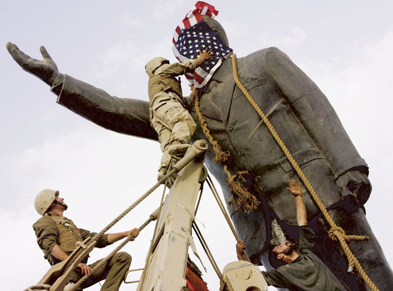 American soldiers cover the face of Baghdad’s Saddam Hussein statue with a U.S. flag. Last week’s 10th anniversary of the war in Iraq sparked a torrent of coverage and commentary.