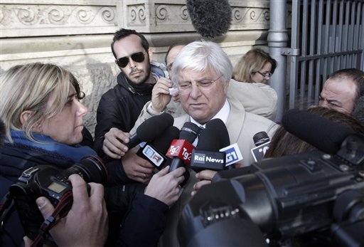 Luciano Ghirga, lawyer of Amanda Knox, center, talks to reporters in front of Italy's Court of Cassation in Rome on Monday.