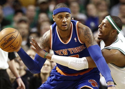 Carmelo Anthony, who scored 29 points Tuesday night for the New York Knicks, keeps the ball away from Paul Pierce of the Boston Celtics during New York’s 100-85 victory at Boston.