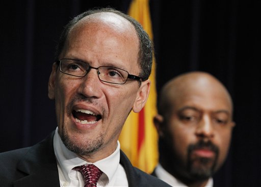 In this May 10, 2012, photo, United States Assistant Attorney General Thomas Perez, left, is joined by Deputy Assistant Attorney General for Civil Rights, Roy Austin, as Perez announces a federal civil lawsuit against Maricopa County Sheriff Joe Arpaio.