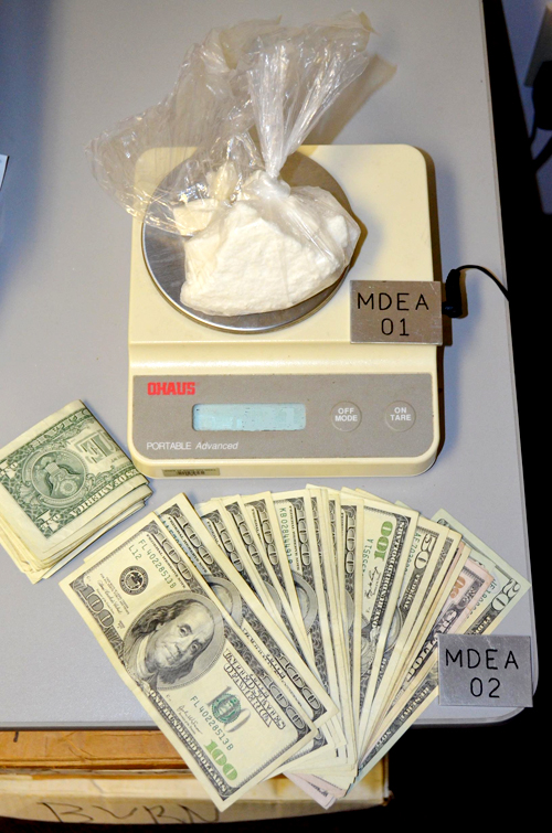 Police say they seized crack cocaine with a street value of about $16,000 and $1,954 in cash from the car driven by Nega Negash.