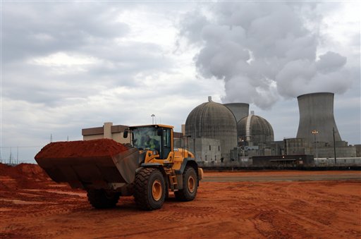 An earth mover works on a new reactor at the Plant Vogtle nuclear power plant in Augusta, Ga., last Dec. 11. One of the plant's existing reactors is shown in the background. Last week, Southern Co. told Georgia regulators that it needed to raise its construction budget for Plant Vogtle by $737 million to $6.85 billion.
