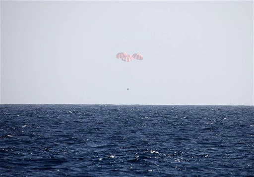 In this image provided by SpaceX, the Dragon capsule uses parachutes to descend to the Pacific Ocean off the coast of Mexico's Baja Peninsula on Tuesday.